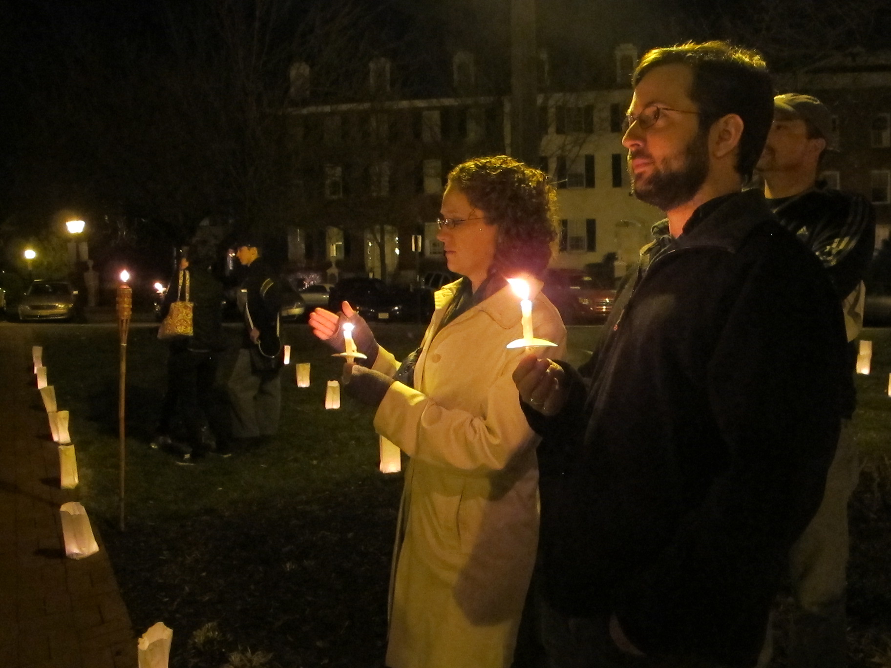 A twentysomething couple holds candles at the Illumination in Frederick.