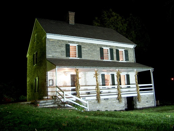 A nighttime view of the stone Hager House, built in the 1700s.