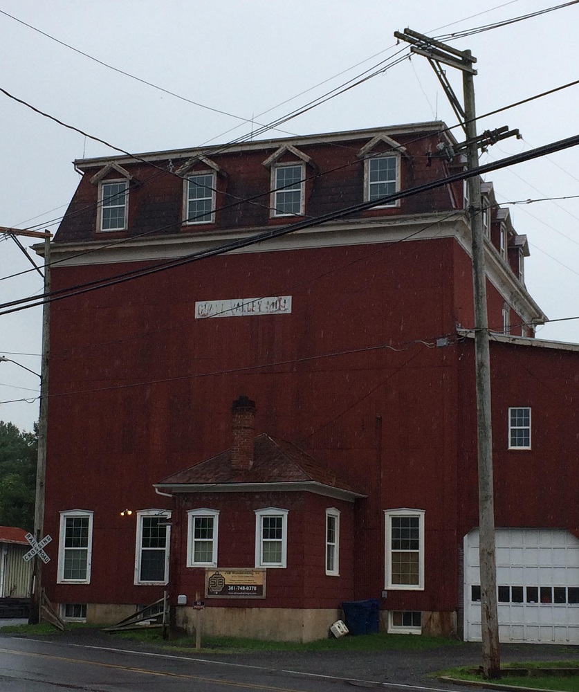 Glade Valley Mill is a four-story red building along a major road in Woodsboro