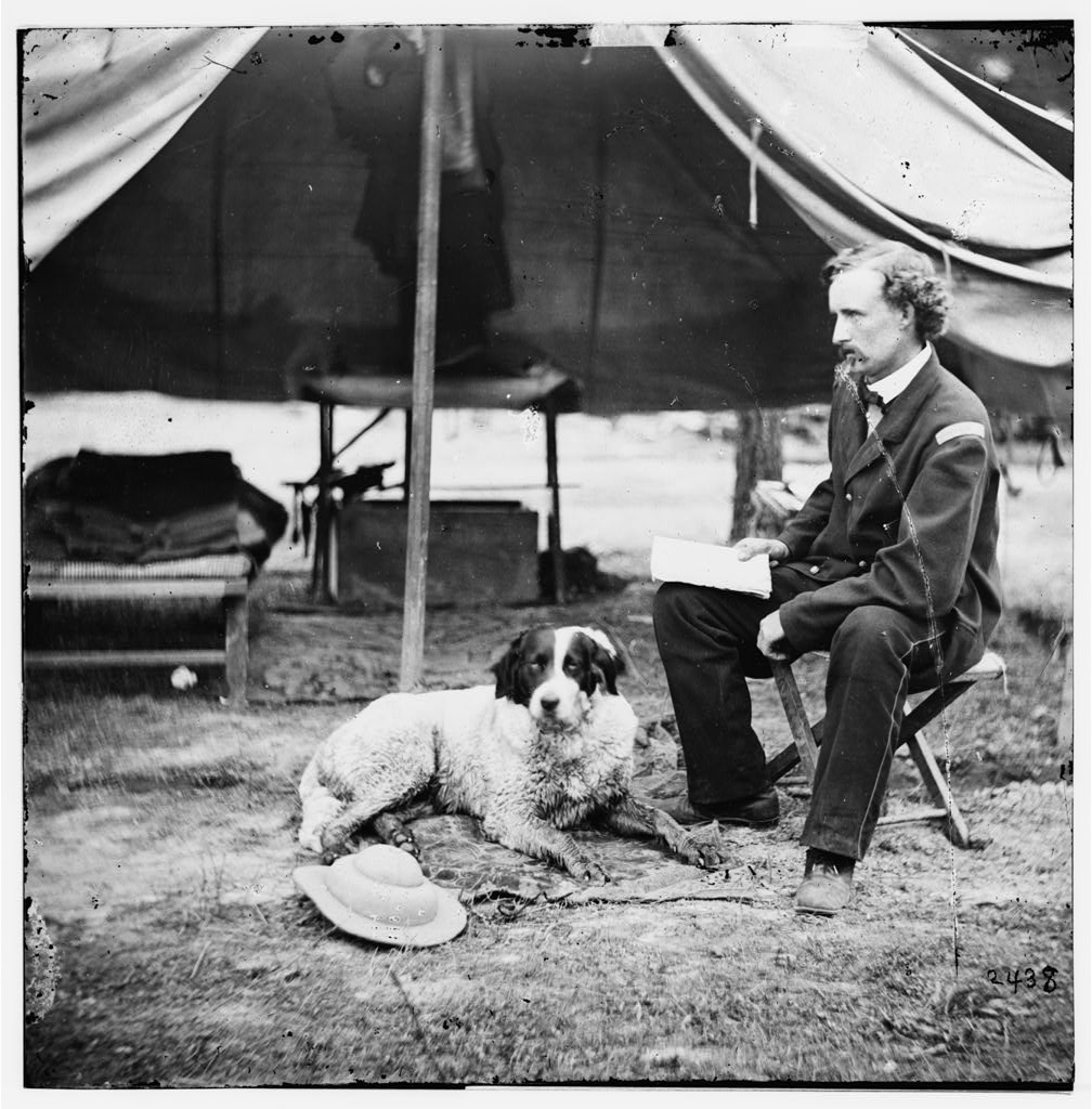 Lt. George A. Custer poses with his dog outside a tent