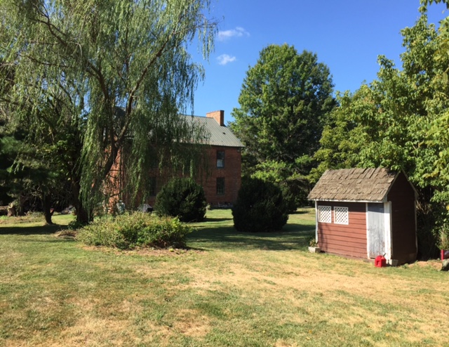 A view of the 1830 Daniel Donnelly house from the rear, along with an outbuilding.